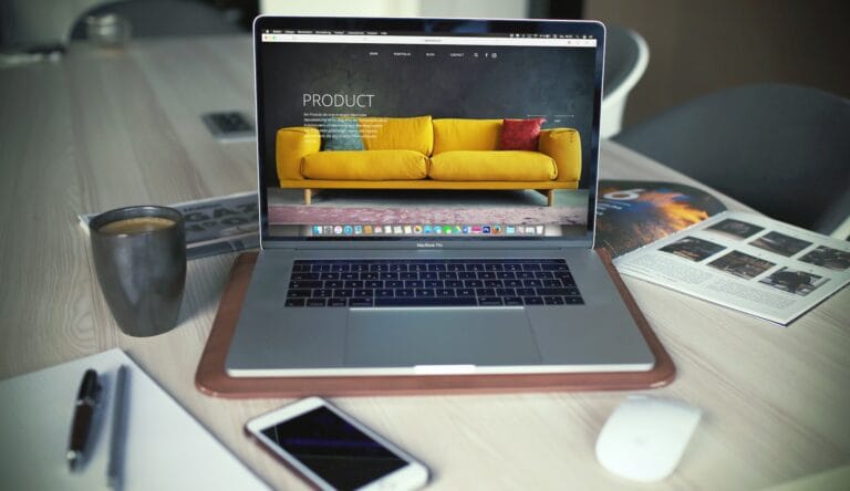 Laptop displaying yellow sofa product